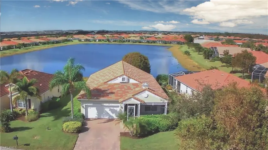 Birds eye view of property with a water view