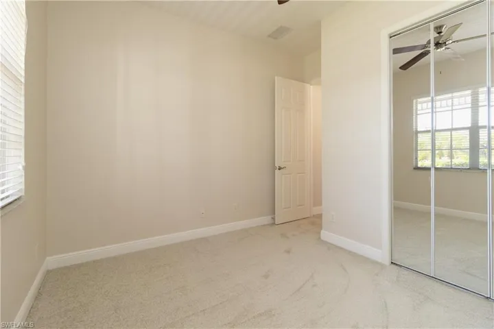 bedroom featuring a closet, carpet, and ceiling fan