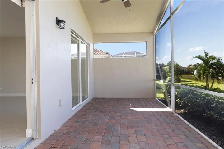 Unfurnished sunroom featuring ceiling fan