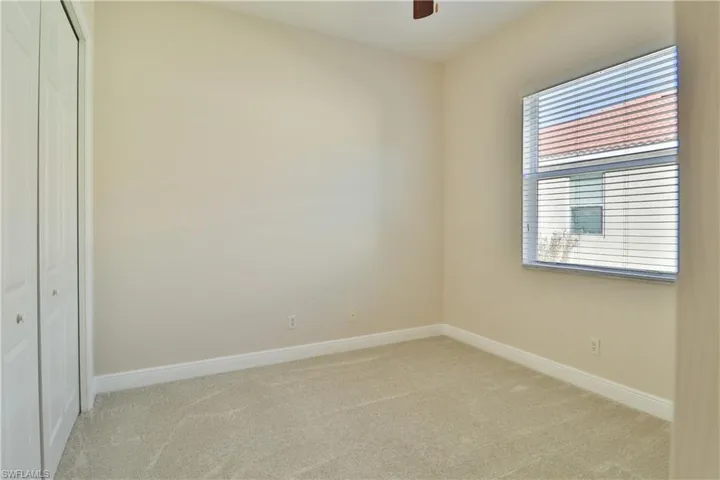 Unfurnished room featuring light colored carpet and ceiling fan