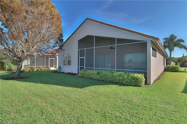 Back of property featuring a yard and a sunroom