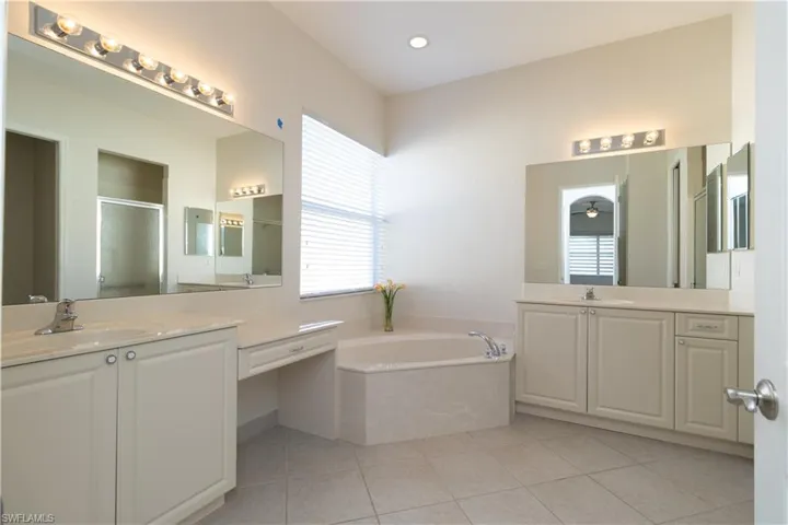 Bathroom with vanity, shower with separate bathtub, and tile patterned flooring