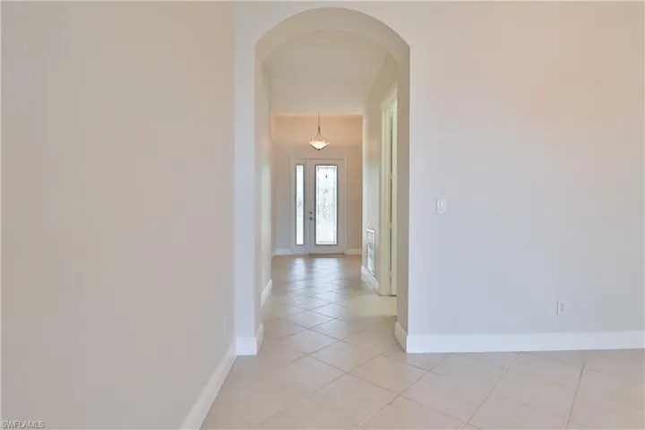 Corridor with light tile patterned floors