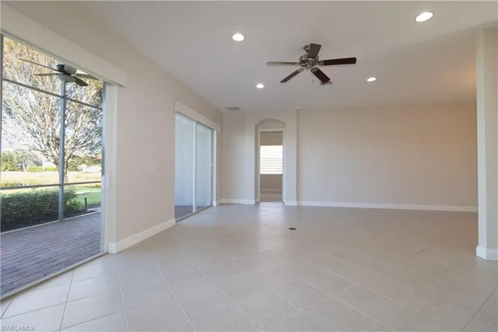 Tiled spare room featuring ceiling fan