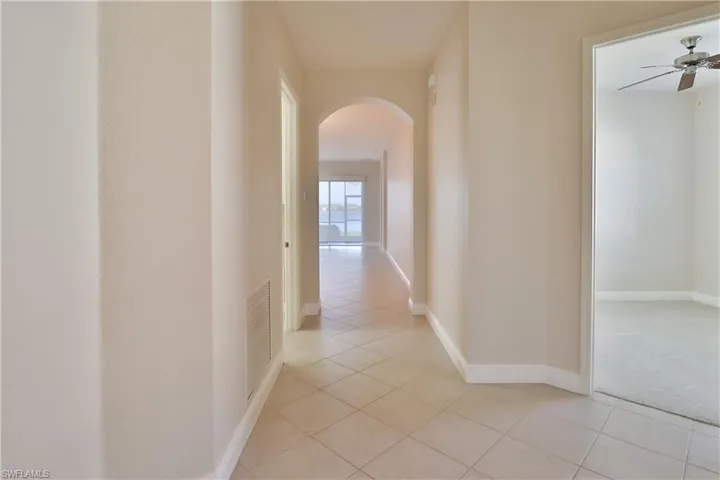 Hallway with light tile patterned flooring