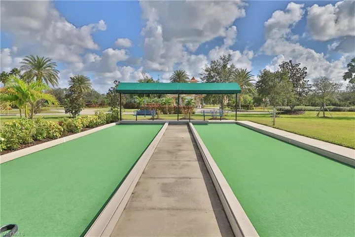 View of property's community with a yard