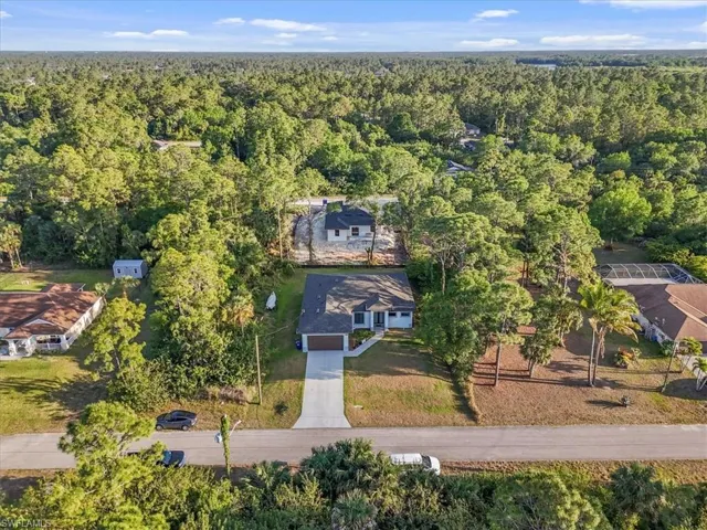 Drone / aerial view with a wooded view
