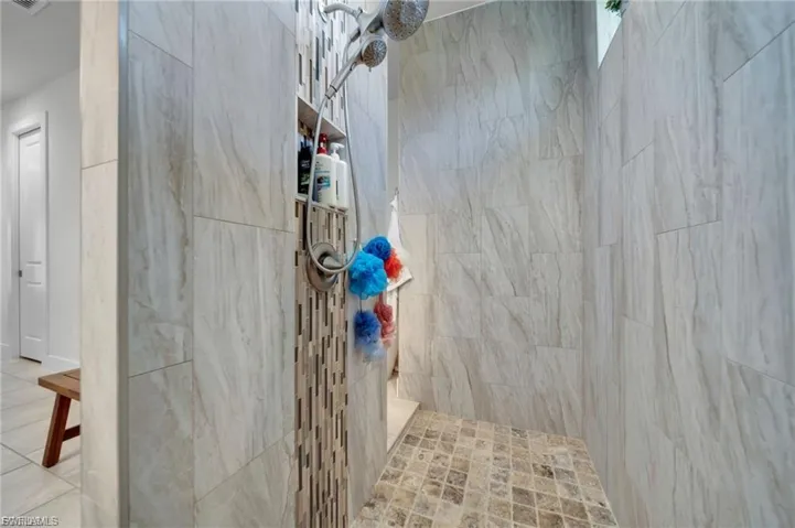 Full bath featuring tiled shower