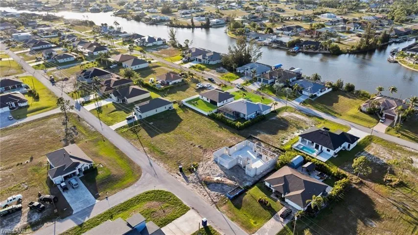 Aerial overview of property's location featuring nearby suburban area and a nearby body of water