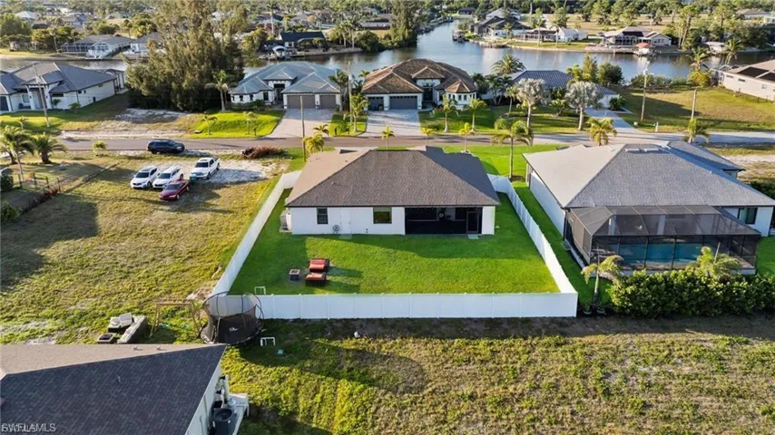 Aerial perspective of suburban area featuring a nearby body of water