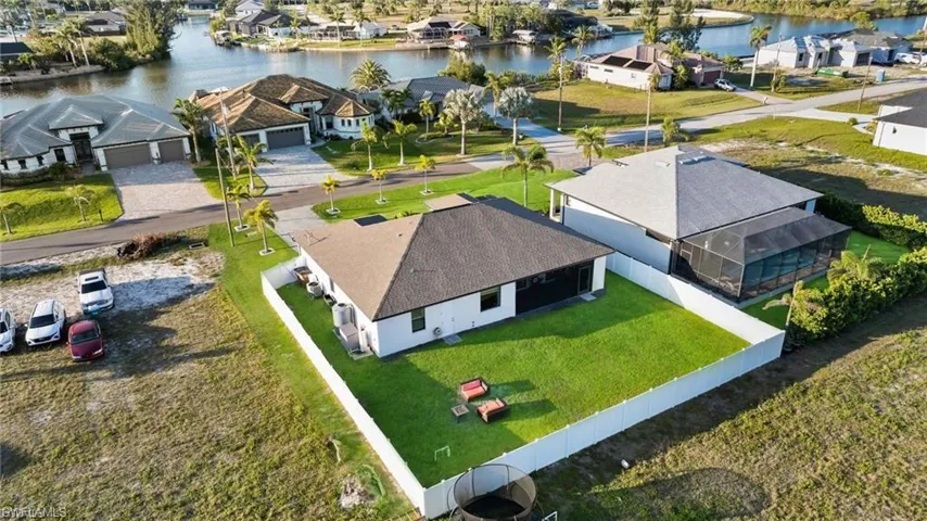Aerial perspective of suburban area with a nearby body of water