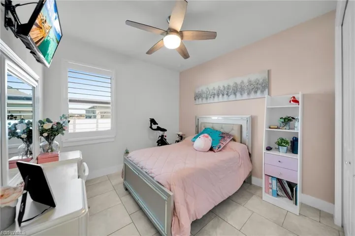 Bedroom featuring ceiling fan and light tile patterned flooring