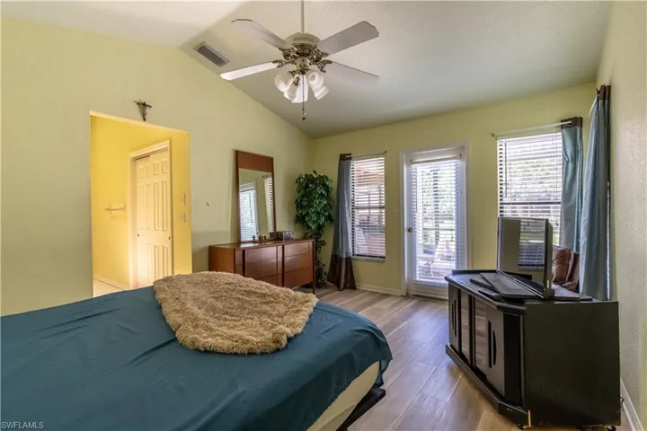 Bedroom featuring lofted ceiling, ceiling fan, and hardwood / wood-style floors
