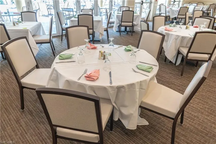 Dining area featuring dark carpet