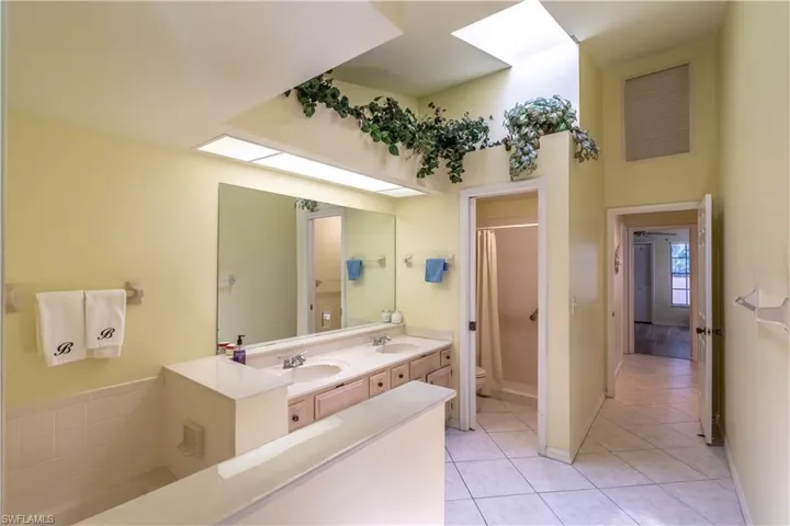 Bathroom featuring tile patterned flooring, vanity, toilet, and a shower with shower curtain