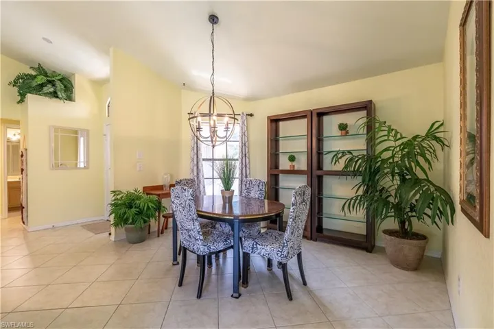 Dining room with a chandelier and light tile patterned flooring