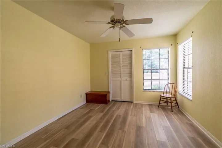 Unfurnished bedroom featuring a textured ceiling, hardwood / wood-style floors, ceiling fan, and a closet