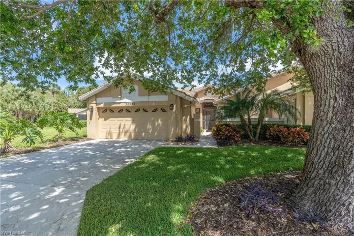 Ranch-style house with a garage and a front yard