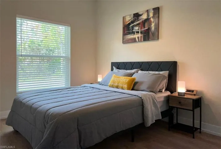 Bedroom with baseboards and wood finished floors