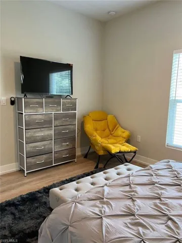 Bedroom with light wood-type flooring and baseboards
