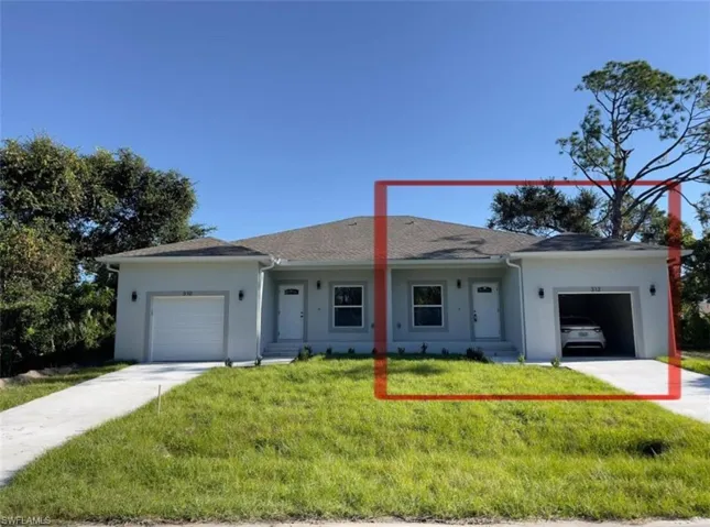 Ranch-style house featuring an attached garage, stucco siding, driveway, and a front lawn