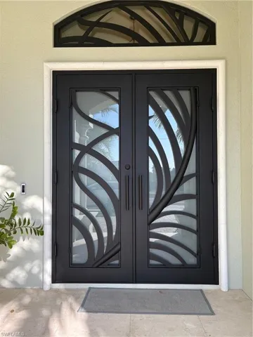 GREETED BY AN ELEGANT AND HANDSOME HEAVY IRON DOOR