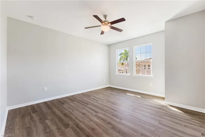Unfurnished room featuring light wood-style floors and ceiling fan