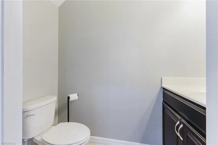 Bathroom with vanity and baseboards