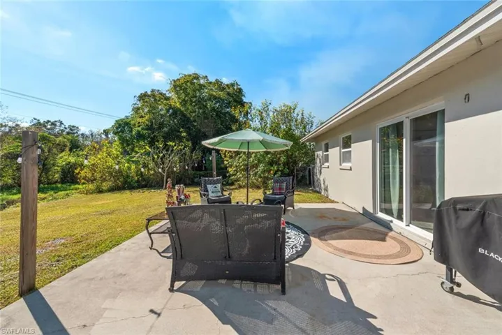 View of patio featuring grilling area and outdoor dining area