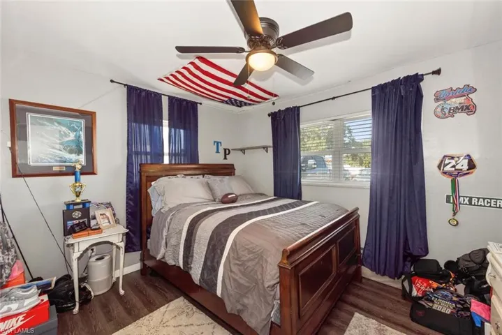 Bedroom with dark wood finished floors and ceiling fan