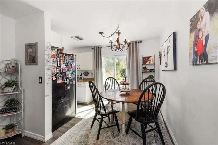 Dining room featuring light wood-type flooring and suspended lighting