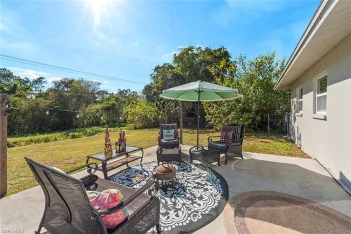Fenced backyard with a patio area and an outdoor hangout area