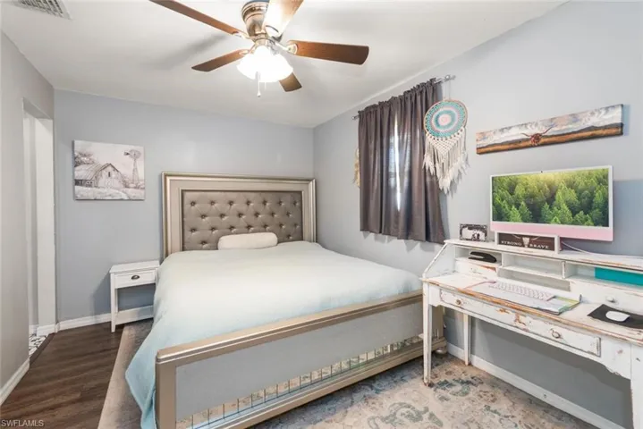 Bedroom with a ceiling fan and baseboards