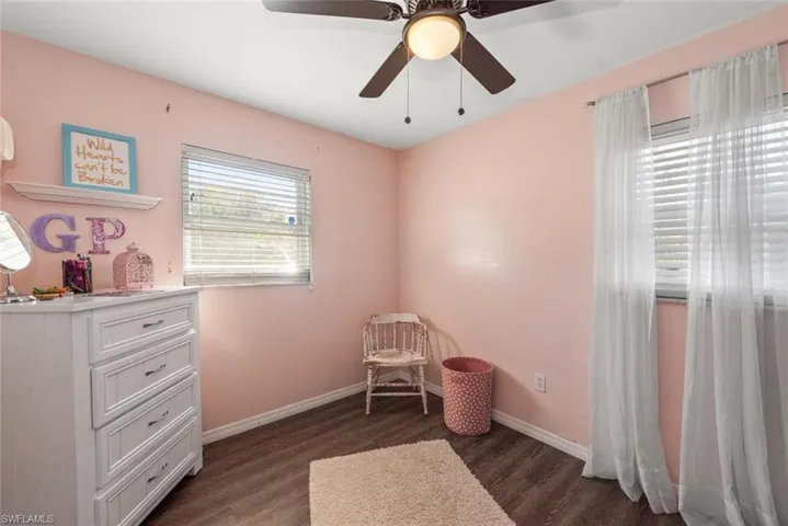 Bedroom featuring dark wood-style floors and ceiling fan