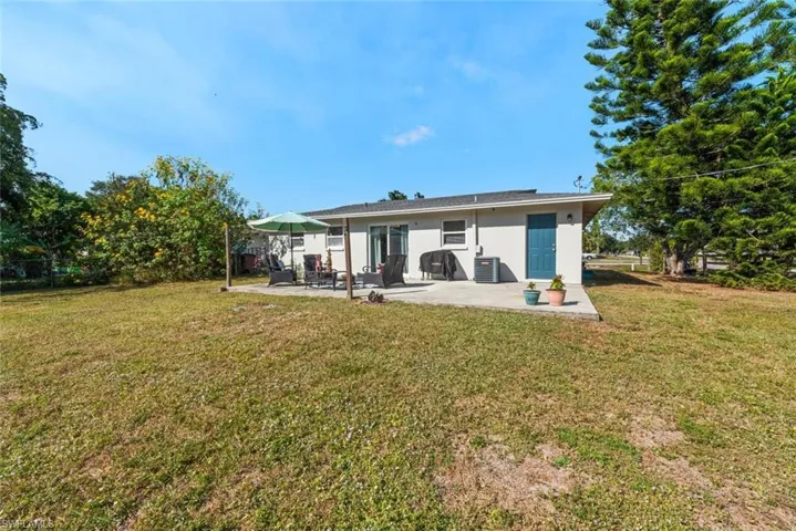 Rear view of property with stucco siding and a patio area