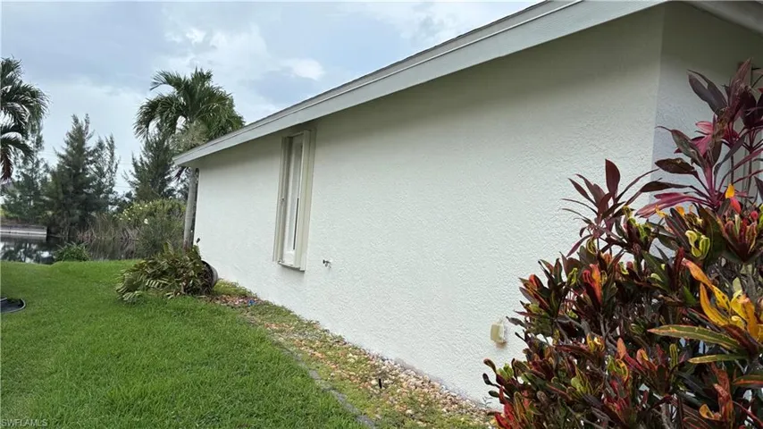 Stucco exterior with a single pane window