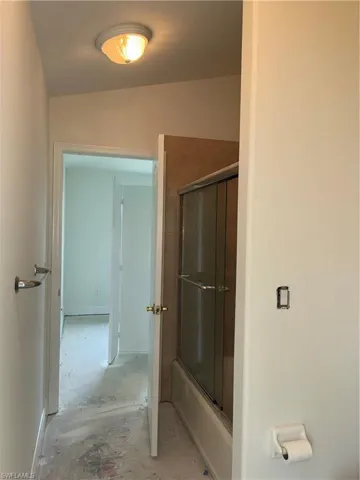 Hallway featuring recessed ceiling lighting, neutral wall finishes, and direct access to multiple rooms