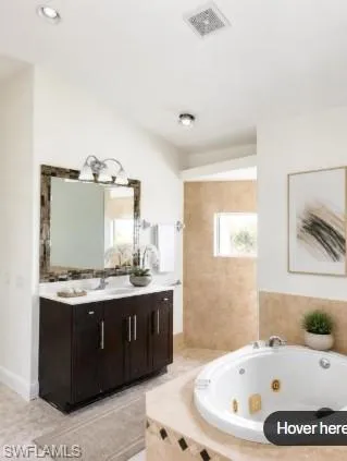 Staged Built-in vanity with a white countertop and wood-finish cabinetry, accompanied by a framed mirror with integrated lighting