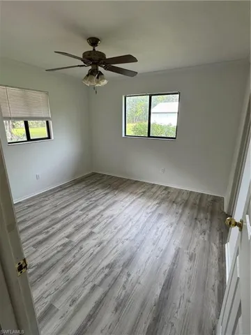 Unfurnished bedroom 1 featuring light wood-style floors and ceiling fan