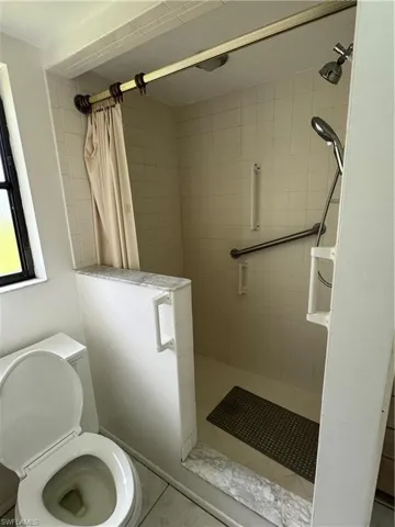 Full bath featuring a stall shower and tile patterned flooring