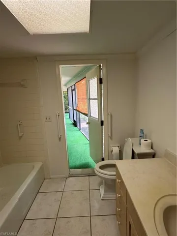 Full bathroom featuring vanity, light tile patterned floors, and shower / bath combination