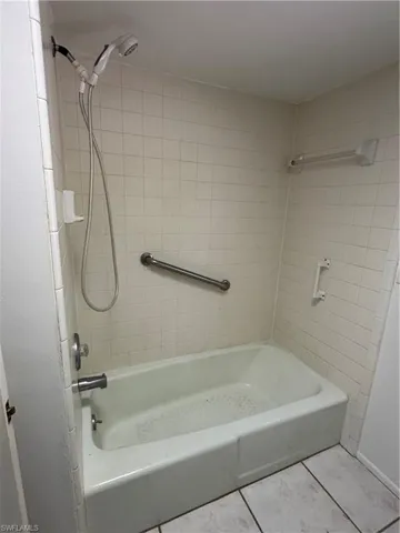 Bathroom featuring tile patterned flooring and shower / tub combination