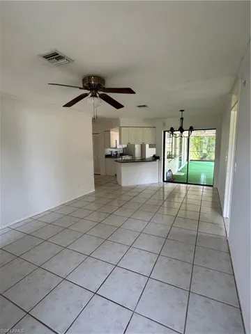 Family /small dining room featuring light tile patterned floors, a ceiling fan, and a chandelier