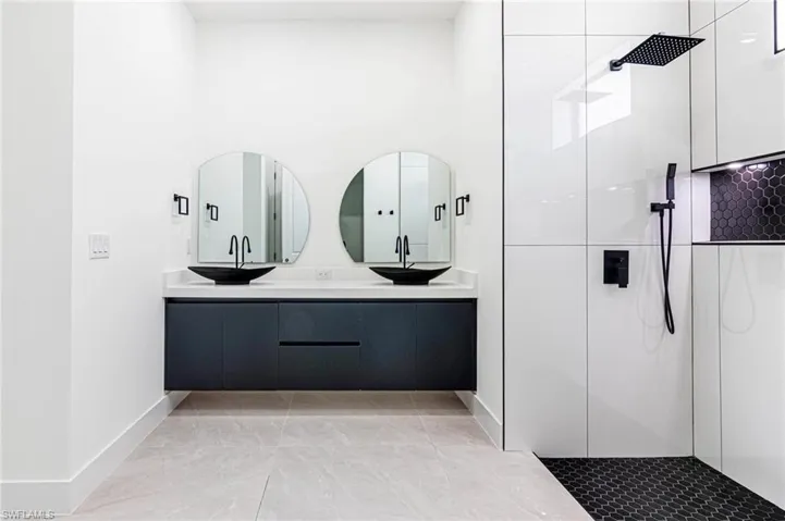 Bathroom with double vanity and walk in shower