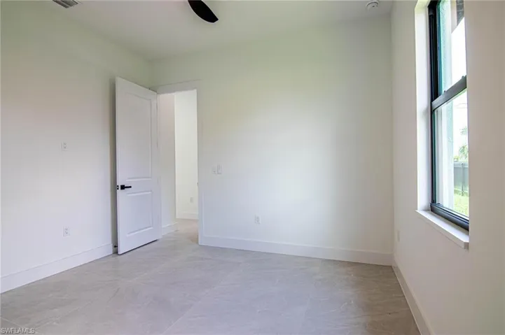 Unfurnished room featuring baseboards