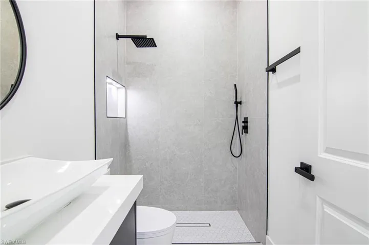 Bathroom with a tile shower and vanity