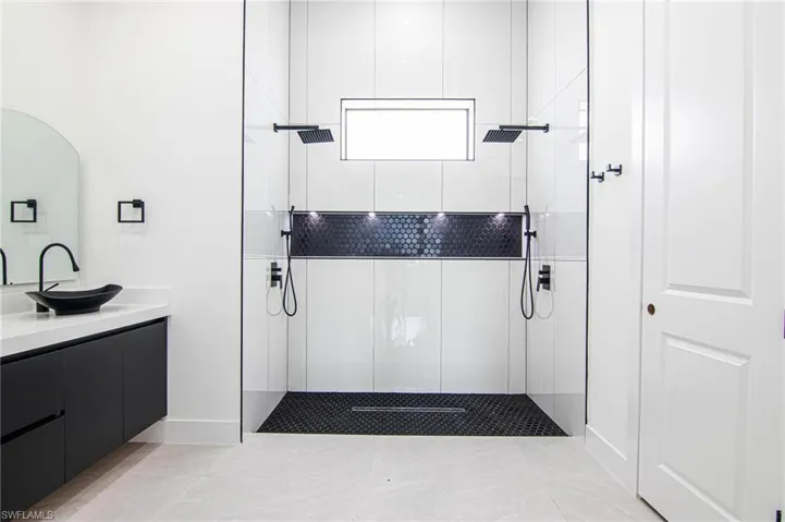 Bathroom featuring walk in shower and vanity