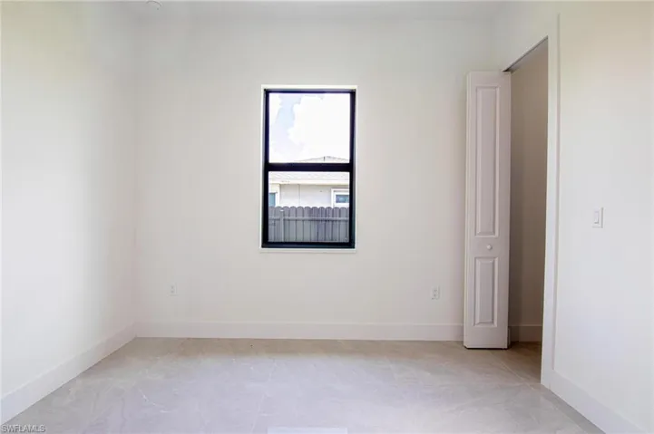 Empty room featuring baseboards
