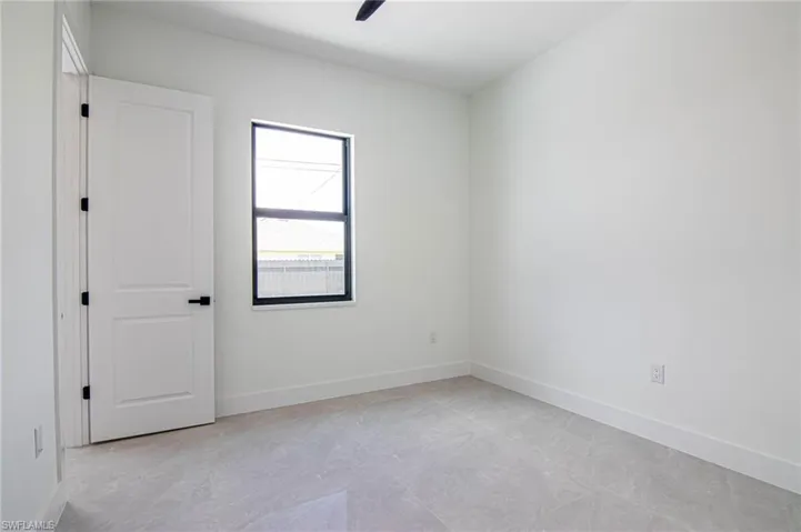 Unfurnished room with baseboards and a ceiling fan