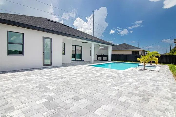 View of swimming pool featuring a ceiling fan, a patio, and a hot tub